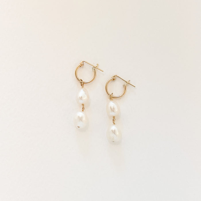 Alina Pearl drop earrings. Pair of delicate 14k gold filled hoops with a drop of two natural white pearls. Hoop diameter .5", total earring length 1.5"