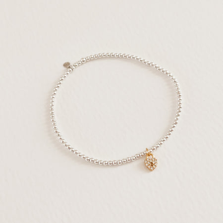 Freya stretch bracelet with delicate 925 sterling beads and a tiny gold, crystal encrusted heart shaped locket. Stretch bracelet, one size fits most. Hand crafted by TAI Jewerly.