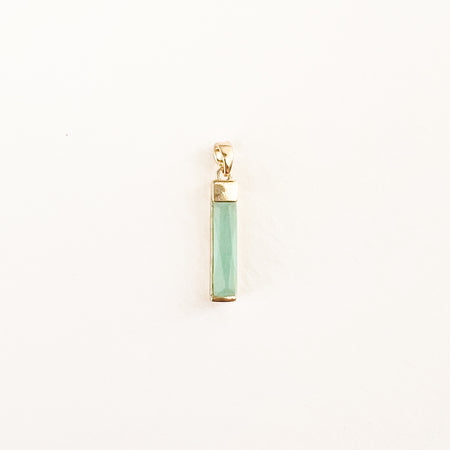 Rectangular crystal baguette charm in a pale seafoam green color with gold filled fittings. Measures 1" long.
