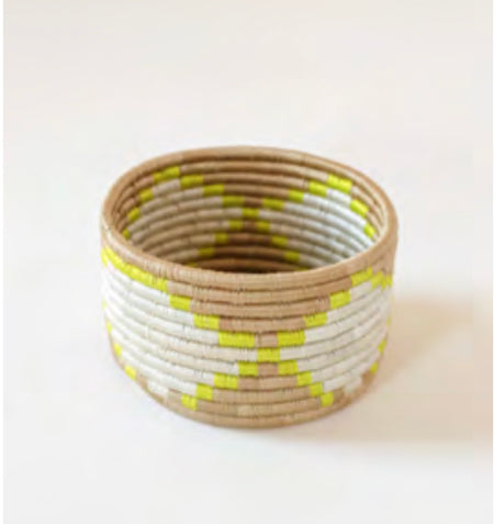 Maya basket in yellow with white and natural grass. Artisan made using sweetgrass wrapped in hand dyed sisal. Circular/cylindrical shape. Measures 4" high, 5" diameter. 