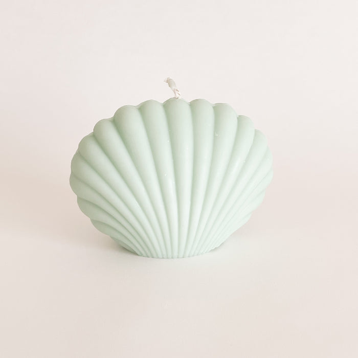 Seaside Shell candle in green adds beach vibes to any space. Makes a great gift. Hand poured in California. 100% unscented soy wax. Measures 3" H 4" W.