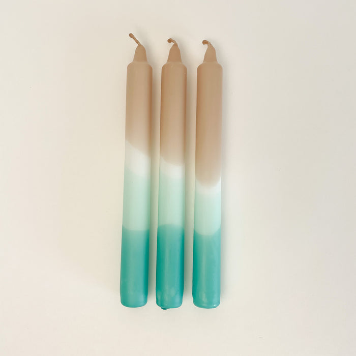 Set of 3 Dip Dye Candles inspired by the shoreline in shades of sand, seafoam green and turquoise add coastal color to your table setting. Hand dipped paraffin candles measure 8" length, 3/4" diameter. Set of 3 come packaged in a box, perfect for hostess gifts. 