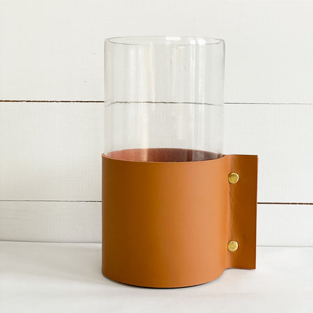 Large vase with leather cuff measures 10"H 5" diameter. Clear glass cylinder vase is wrapped in a "vegan" leather cuff and finished with brass snaps. A modern and elegant way to style your favorite branches or blooms.