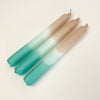 Set of 3 Dip Dye Candles inspired by the shoreline and hand dipped in shades of sand, seafoam green and turquoise add coastal color to any table setting. Hand made paraffin candles measure 8" length, 3/4" diameter.