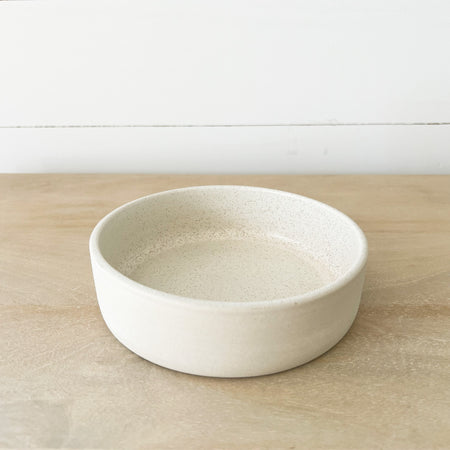 Mesa stoneware bowl. Small batch stoneware made in Portugal. Modern linear silhouette perfect for the modern table. Matte creamy white glaze. 6.25" diameter 1.75" high.