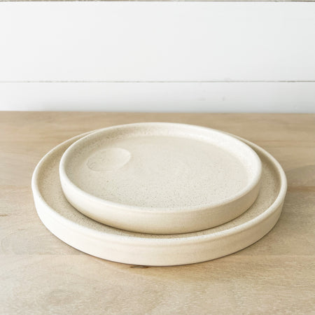 Mesa stoneware plates. Small batch stoneware made in Portugal. Modernist shape finished in a creamy matte white glaze, perfect for the modern bohemian table. Small and large plate shown. Each sold separately.