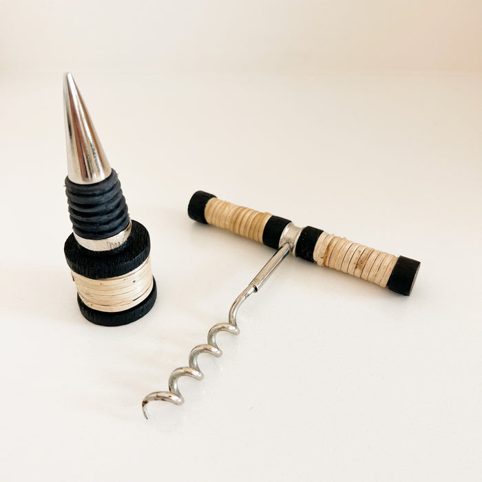 Brisbane corkscrew and bottle stopper made of stainless steel with a natural rattan handle and black trim. Each sold separately.