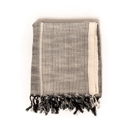 Monterey Towel. Dark graphite grey stripes on a natural unbleached cotton base. Ends are finished with hand knotted fringe tassels. Hand loomed in natural raw Turkish cotton. Free of synthetic dyes and harmful chemicals. Perfect for bath, pool or beach. Measures 40" x 70".