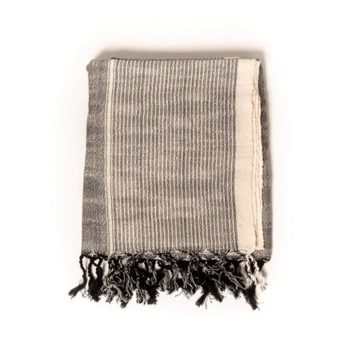 Laguna Towel. Dark graphite grey stripes on a natural unbleached cotton base. Ends are finished with hand knotted fringe tassels. Hand loomed in natural raw Turkish cotton. Free of synthetic dyes and harmful chemicals. Perfect for bath, pool or beach. Measures 40" x 70".