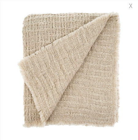 Lina waffle throw. Soft, light weight sand colored throw woven in a blend of cotton, polyester and linen. Measures 50" x 60". Machine wash gentle, tumble dry low.