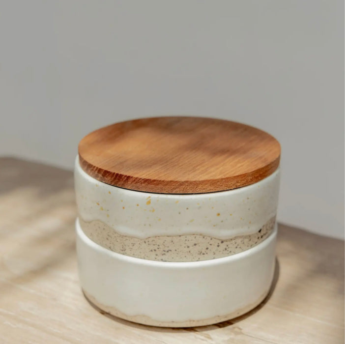 Wabi ceramic ramekins. Set of two stacking stoneware ramekin dishes with a wood lid. Hand crafted in a sand stoneware dipped in a creamy white glaze. 4" diameter 3" height stacked.