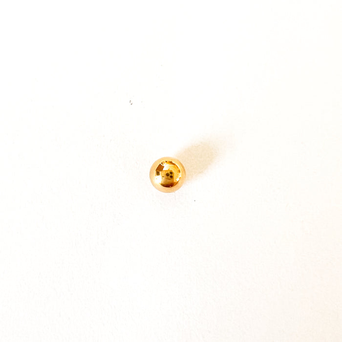 Gold bead stud earring by Ellie Vail. Simple gold ball stud with a flat screw back for comfort. Sold individually. Sweat, water and tarnish resistant. Made of marine grade stainless steel with gold plating.