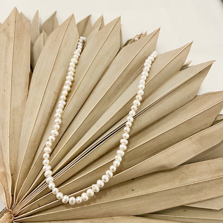 White Keishi pearl necklace. 16" length with a 3" extender and lobster claw clasp. Made by Momento Mori Designs NYC.