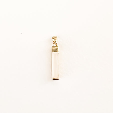 Rectangular crystal baguette charm in a pale nude color with gold filled fittings. Approximately 1" long.