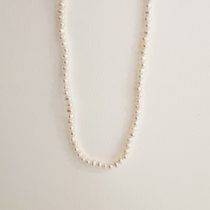 Simple and classic white pearl necklace. Made of Keishi pearls, known for their organic shape. 16" length with 3" extender and lobster claw clasp.