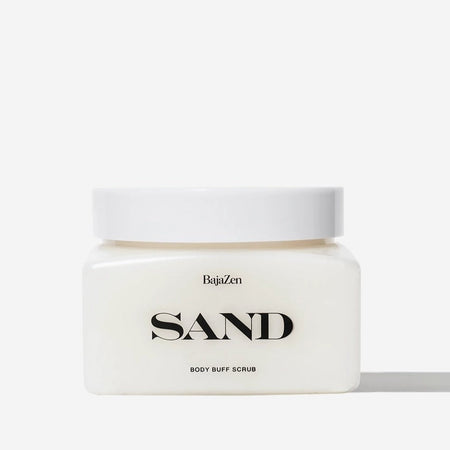 SAND body buff scrub by Baja Zen. Square frosted plastic jar of body scrub made with replenishing oils and pure sugar crystals to exfoliate and nourish the skin. Scent of beach jasmine, sea salt and orange blossom. Contains 14 oz./397 g.