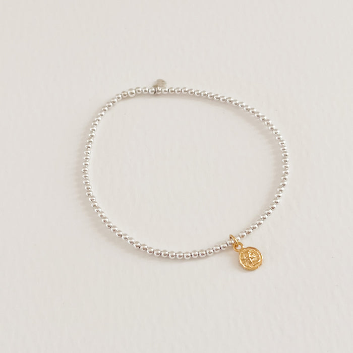 Florence Stretch Bracelet. Made with delicate 925 sterling silver beads finished with a small gold coin charm. Hand crafted by TAI Jewerly.