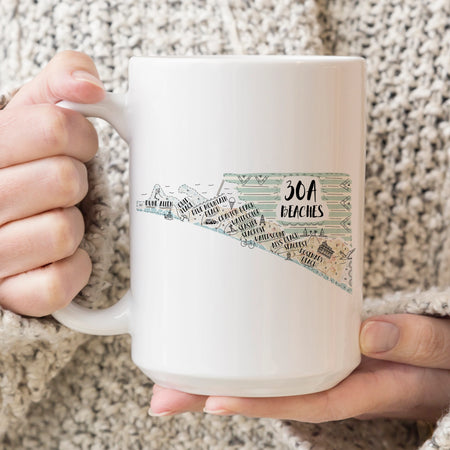 White mug with '30A Beaches' design held by a person. 15 oz ceramic mug. Dishwasher & microwave safe.