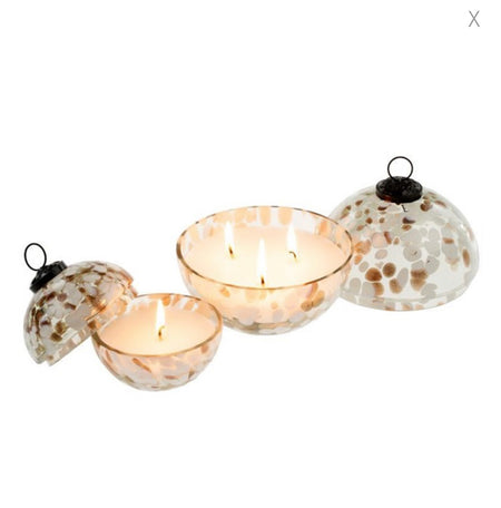 Small and large glass bauble ornament candles shown lit with top removed. Clear glass sphere ornament with swirls of white and amber confetti. Top of glass ornament removes to show a white candle with the scent of amber and spruce. Small measures 3.5" diameter. Large measures 5" diameter.