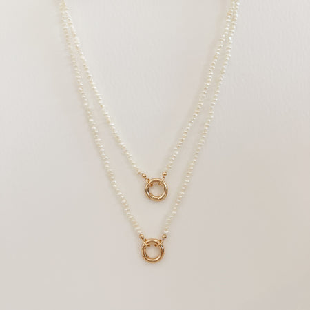 15" and 18" pearl charm builder necklaces. Made with small white Keishi pearls. Gold filled ring clasp is designed to hold charms. Each sold separately.