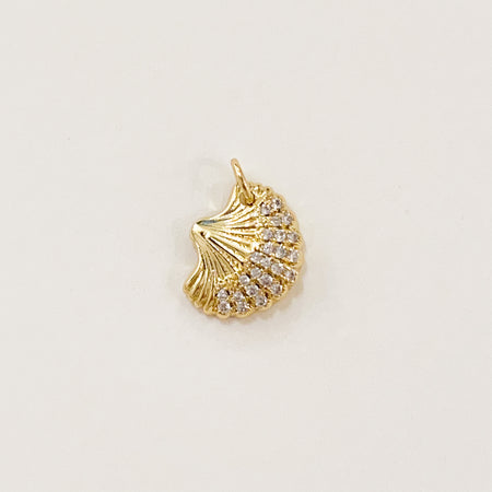 Sparkle shell charm. 14k gold filled shell inset with clear CZ crystals. Designed to mix and layer on our charm builder necklaces and earrings. Measures: 5/8" high 1/2" wide.
