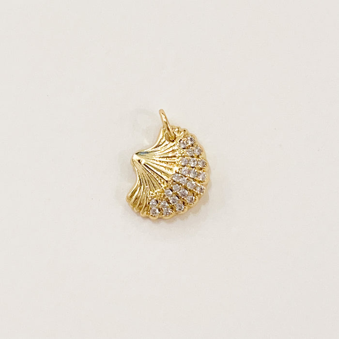 Sparkle shell charm. 14k gold filled shell inset with clear CZ crystals. Designed to mix and layer on our charm builder necklaces and earrings. Measures: 5/8" high 1/2" wide.