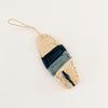 Surf board ornament hand woven in natural raffia with two blue stripes and a blue fin. Each sold separately. Hand woven by skilled artisans in Uganda.