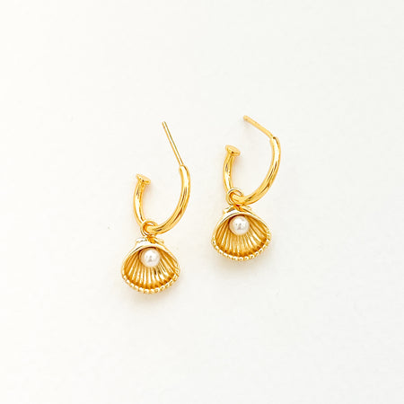 Cove Earrings. Delicate 18k gold vermeil hoops with a gold shell charm featuring a tiny white pearl center.  Hoop measures .5" diameter, 1" total length.