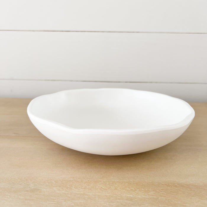 White melamine "Cloud" pasta bowl. Part of the Nube collection by Beatrix Ball. Low profile, organic shape with an matte white finish. Measures 9" diameter, 2" depth.