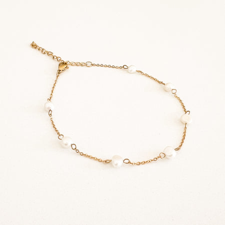 Pearl and gold chain anklet by Ellie Vail. Sweat, water and tarnish resistant. Chain made of marine grade stainless steel with gold plating. 8.5" length with 2" extender.