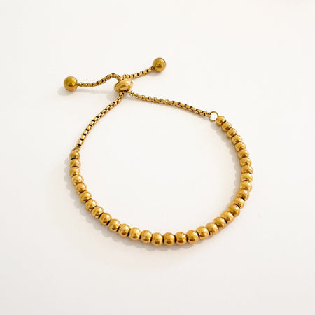 Regina beaded ball bracelet by Ellie Vail. Adjustable gold bead bracelet with adjustable box chain pulls finished with gold beads. One size fits most. Sweat, water and tarnish resistant. Made from marine grade stainless steel with gold plating.