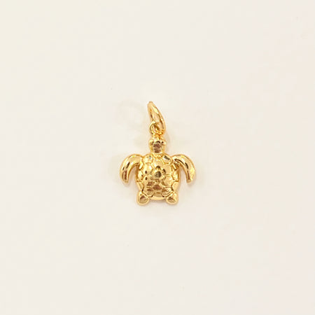Golden sea turtle charm. 14k gold filled charm designed to mix and layer on our charm builder necklaces and earrings, sold separately. Measures 3/8" length 1/2" width.