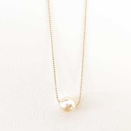 Luna Pearl Necklace. A delicate 18K gold filled ball chain with a large solitaire pearl. Measures 15" length with a 2" extender.