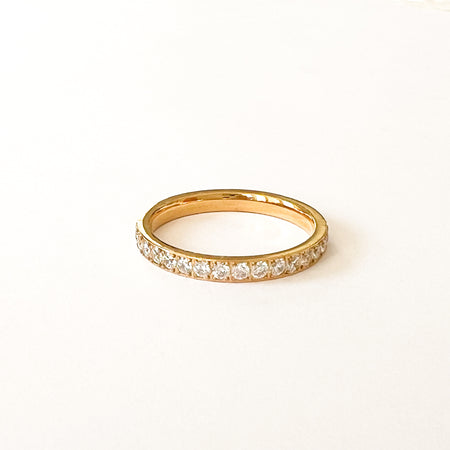Velia eternity ring by Ellie Vail. Slim gold eternity rings with clear CZ stones set in around entire ring. Available in two size. Sweat, water and tarnish resistant. Made of marine grade stainless steel with gold plating and clear CZ stones.