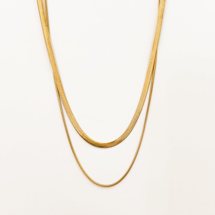 Cassia double chain necklace by Ellie Vail. 15" gold snake chain layered over a 17" slim snake chain. Sweat, water and tarnish resistant. Gold plating over marine grade stainless steel.