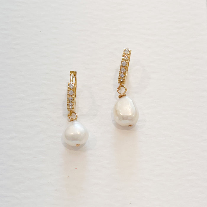 Pearl drop huggie earrings. 18k gold vermeil hoops encrusted with CZ crystals and a small white pearl drop. 