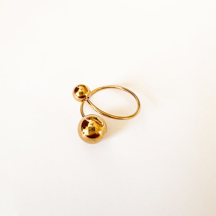 Claudia twist ring by Ellie Vail. A gold spiral ring with open ends. Each end finished with a gold sphere. Sweat, water and tarnish resistant. Made of marine grade stainless steel with gold plating. One size fits most. 