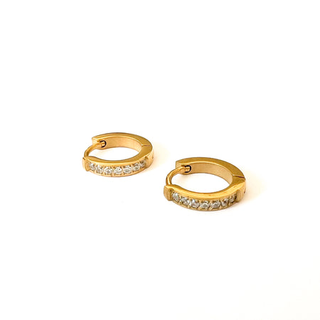 Tinsley huggie earrings. Delicate gold clicker hoops with clear CZ pave'. Sweat, water and tarnish resistant. Made of marine grade stainless steel with gold plating and clear CZ stones.