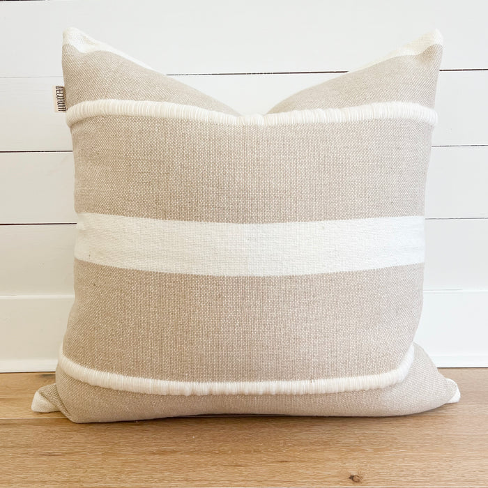 Camden Stripe Pillow. Luxury decorative pillow in a sand hopsack weave with textural ivory stripes. Made of 100% New Zealand wool. 26" square pillow, zip closure. Down insert included.