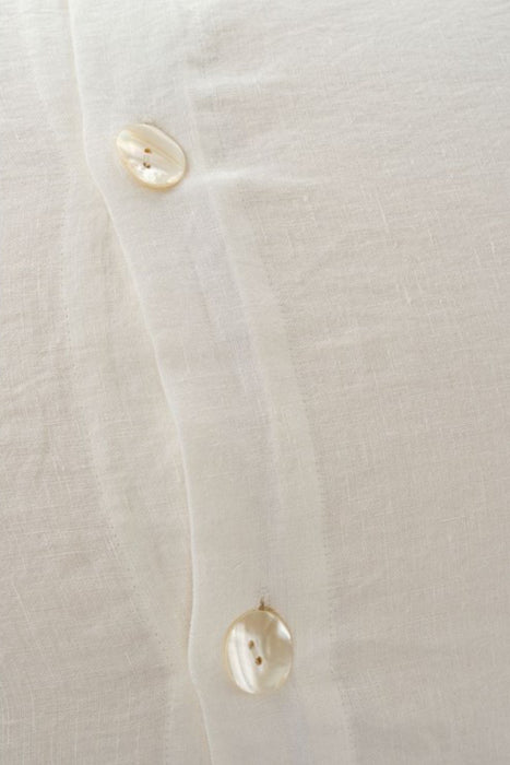 Back pearl button through envelope closure on ivory linen pillow sham. Sold as a set of 2 shams and matching duvet cover.