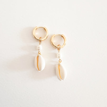 Byron Cowrie Shell earrings. 18k gold plated clicker hoops with pearl and cowrie shell pendant drop. Pendant is removable, hoop can be worn alone. Hoop diameter .5", 1.75" total length