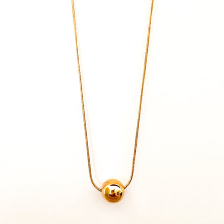 Melinda Necklace by Ellie Vail. Slim gold snake chain with a solitary gold sphere. Sweat, water and tarnish resistant. Made of marine grade stainless steel. 16" length with 2" extender.