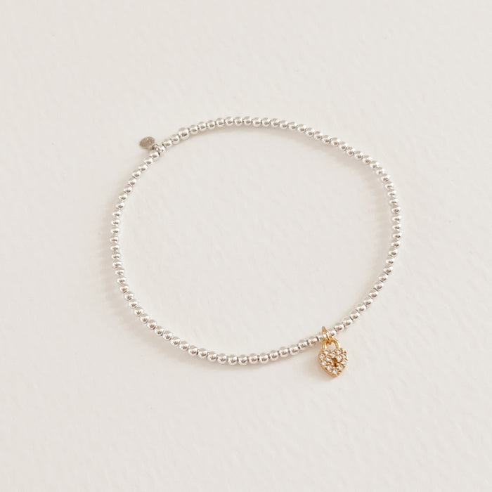 Freya stretch bracelet with delicate 925 sterling beads and a tiny gold, crystal encrusted heart shaped locket. Stretch bracelet, one size fits most. Hand crafted by TAI Jewerly.