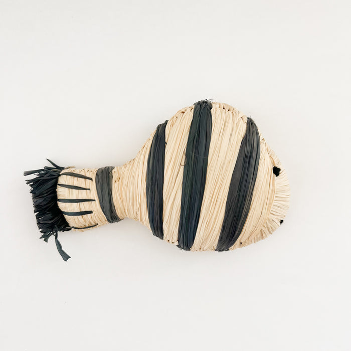 Stripe fish ornament hand woven in natural and dark blue raffia. Hand crafted by skilled artisans in Uganda. Each piece sold individually.
