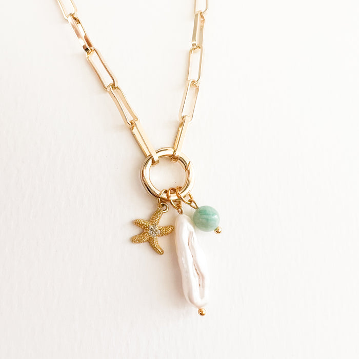 Liya charm builder necklace. 18K gold filled paperclip chain with round carabiner clasp for layering charms. Starfish, pearl and Amazonite charm sold separately.