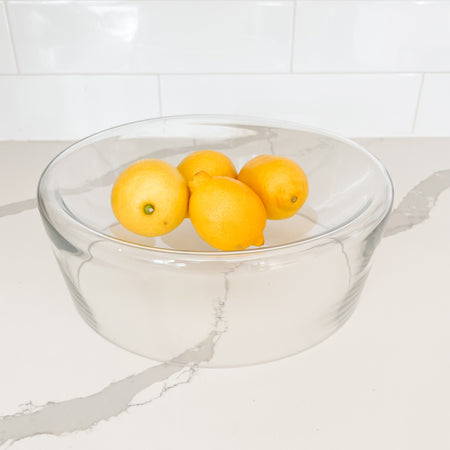 Aero glass serving bowl holding 4 lemons.  Clear glass serving bowl with a curved concave surface ideal for the modern kitchen. Measures 11.75" diameter x 4.25" height. Holds 16 oz. Lemons not included.