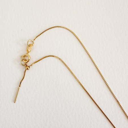 Delicate gold filled diamond cut box chain with ring clasp and pull adjuster. Necklace adjusts up to 18 inch length.