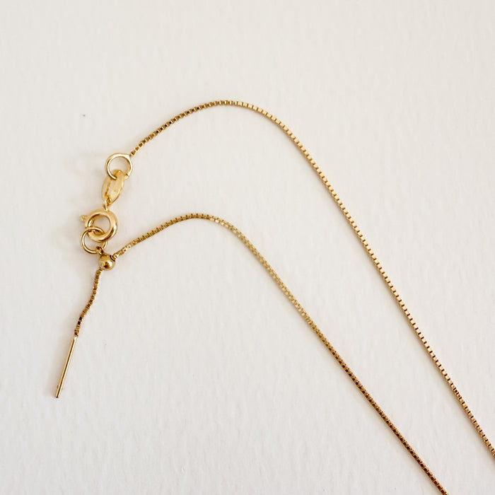 Delicate gold filled diamond cut box chain with ring clasp and pull adjuster. Necklace adjusts up to 18 inch length.