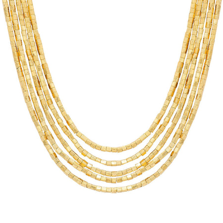 A multi-strand gold beaded necklace made of small rectangular metallic beads, in varying lengths on plain white background. Designed by Marcia Moran. 18k gold plated over brass.