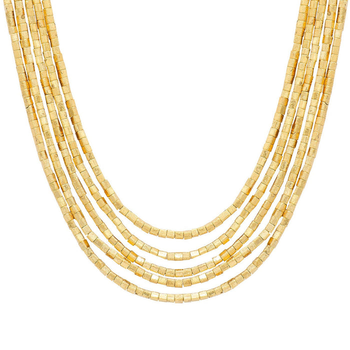 A multi-strand gold beaded necklace made of small rectangular metallic beads, in varying lengths on plain white background. Designed by Marcia Moran. 18k gold plated over brass.